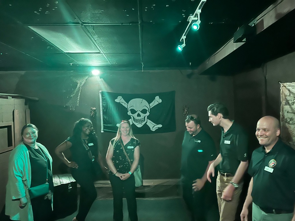 Group of players inside a pirate-themed escape room at Worlds Away Escape in Winchester VA