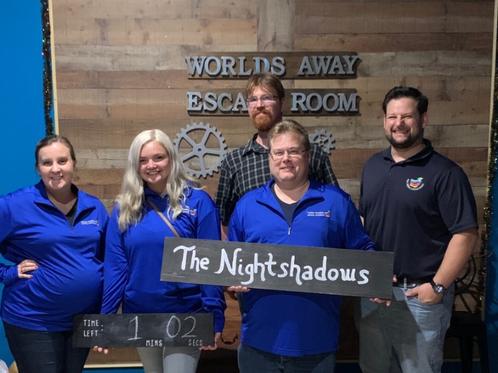 Winning escape room team celebrating at Worlds Away Escape Room in Winchester VA