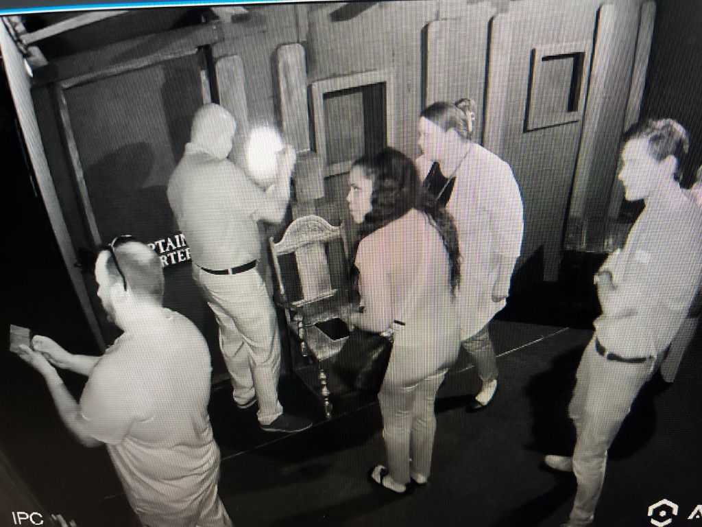 Players solving puzzles inside an immersive escape room at Worlds Away Escape in Winchester VA