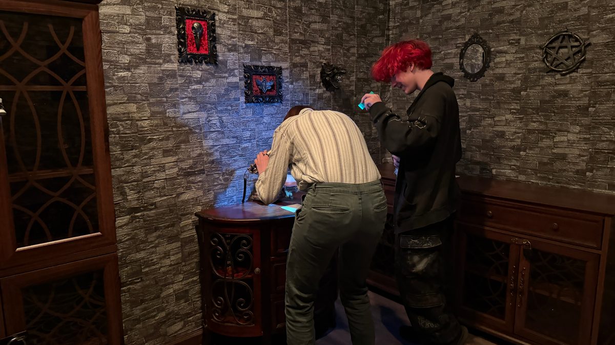 Players solving puzzles in The Vampyr Quest escape room